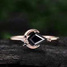 a black diamond ring on top of a piece of wood