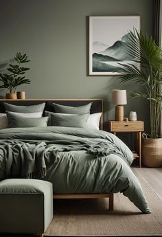 a bed with green sheets and pillows next to a painting on the wall above it