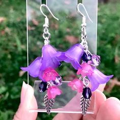 Gorgeous lucite earrings  these are gorgeous and festive , I used various bell flower charms and light fuchsia tulip shaped charms with pearls inside , silver toned and I also used purple crystals , unique .  Ear wires are nickel free Unique Purple Earrings With Ear Wire, Whimsical Dangle Earrings With Flower Charm, Bohemian Purple Dangle Crystal Earrings, Purple Flower-shaped Whimsical Jewelry, Whimsical Purple Flower Jewelry, Whimsical Purple Flower-shaped Jewelry, Unique Single Purple Earring, Dangle Resin Flower Charm Earrings, Resin Flower Charm Dangle Earrings