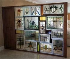 a room with many different stained glass pieces on the wall