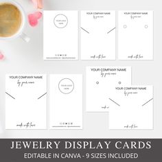 the jewelry display cards are shown on top of a table with pink flowers and hearts