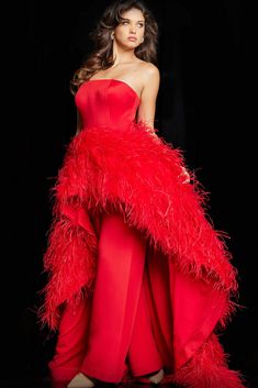 a woman in a red dress with feathers on it