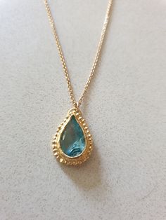 This 14k gold filled Blue Topaz necklace was designed in an antique style, with a bright Turquoise colored pendant in a teardrop shape. The gemstone birthstone necklace is handmade and delicate and available both in 14 karat gold filled and sterling silver. The Blue Topaz is lab made. Dimensions: Pendant height is 0.5 inches and it is 0.3 inches wide. This pendant necklace is available in multiple lengths. Please choose on checkout. The Blue necklace is a great birthstone necklace for mom and th Gold Teardrop Pendant Necklace With Birthstone, Gold Drop Necklace With Birthstone Teardrop Pendant, Gold Birthstone Drop Necklace, Gold Drop Necklace With Birthstone, Gold Pear-shaped Drop Necklace With Gemstone, Yellow Gold Teardrop Gemstone Drop Necklace, Handmade Gold Teardrop Drop Necklace, Antique Coin Necklace, Necklace Gold Pendant