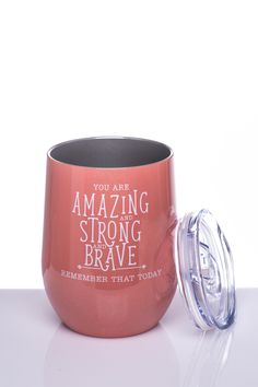 a red cup with the words you are amazing and strong to brave printed on it