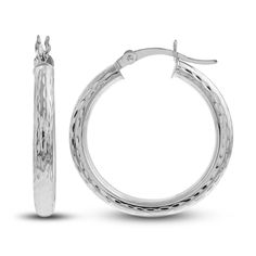 Dynamic 25mm hollow round tubes are embellished with distinctive diamond-cut patterns in these stylish women's hoop earrings. Fashioned in 14K white gold, the earrings secure in place with hinged backs. Engraved Hoop Earrings For Anniversary, White Gold Round Hoop Earrings For Pierced Ears, White Gold Round Hoop Earrings, Elegant Engraved Small Hoop Earrings, Silver Diamond Cut Hoop Earrings, Small Hoop Diamond Cut Earrings For Anniversary, Engraved Small Hoop Jewelry, Polished Round Hoop Earrings Fine Jewelry, Fine Jewelry Round Hoop Earrings With Shiny Finish