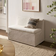 a white couch sitting on top of a rug in a living room