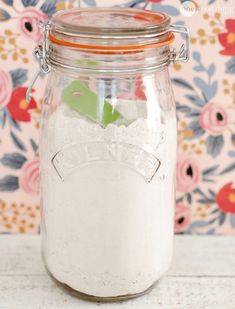 a glass jar filled with white powder on top of a table