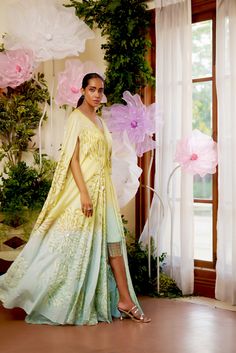 Feel the summer breeze in this flowy Zinnia Kaftan. It is beautifully adorned with floral motif embroidery all over, highlighted with golden and aqua-hued sequence work. To give it that elegant look, an ombre hue of aqua is added at the bottom of the Cape. To match the cape, A fully sequenced dress balances the sophistication and adds a modern touch to the outfit. This summer festive season, this flowy attire with pristine hues is the perfect choice to go with. Cape-style kaftan is covered with Spring Anarkali Kurta For Reception, Green Traditional Drape Dress For Spring, Green Spring Dress With Traditional Drape, Floor-length Georgette Kaftan For Spring, Spring Designer Maxi Dress, Designer Spring Maxi Dress, Summer Bohemian Georgette Kurta, Spring Maxi Length Georgette Kaftan, Bohemian Georgette Dress For Reception