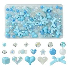 various blue and white beads are in a plastic container with some other items around it