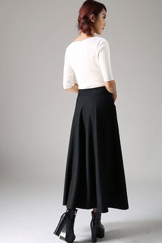 "Look elegant and stylish at all times and for any occasion in this long black classical A-line skirt. This flared women skirt with double stitching detail at hip pockets oozes understated sophistication. This very versatile winter skirt can be worn casually with knitwear or more formally with a crisp white blouse.This is a timeless investment piece you'll have in your wardrobe for years to come. Choosing black makes it so easy to pair with a variety of blouses and jackets. Scientific studies ha Classic A-line Maxi Skirt For Formal Occasions, Elegant A-line Bottoms For Winter, Chic Wool A-line Bottoms, Classic Gathered Maxi Skirt, Elegant Flared Maxi Skirt With Pockets, Elegant Fitted Maxi Skirt With Pockets, Elegant Fall Skirt With Wide Hem, Elegant Fall Maxi Skirt With Pockets, Elegant Wide Leg Maxi Skirt For Fall