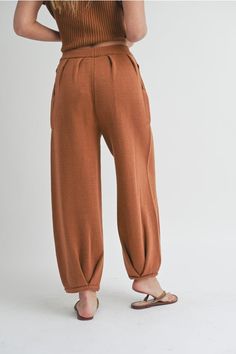 Women's Loose Pleated Joggers Drawstring Knit Lounge Pants Introducing our latest arrival: Drawstring Knit Lounge Pants! Available in two trendy colors, these pants boast a drawstring, convenient side pockets, pleated accents, and a cozy jogger style. Made with soft ribbed fabric, you'll never want to take them off. With a cute, cozy, and chic aesthetic, these pants feature a loose fit for maximum comfort. Complete the look by pairing them with our matching shirt (sold separately). Trust us, you Knitting Pants, Moroccan Oil Hair, Long Sleeve Outerwear, Knit Bottom, Fashion Joggers, Short Sleeved Sweaters, Knit Pants, Beauty Favorites, Lounge Pants