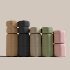 thermos are stacked on top of each other in different colors and sizes,