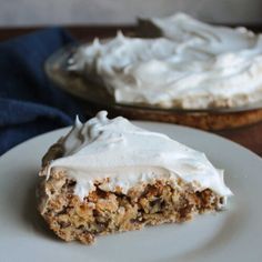 a piece of cake sitting on top of a white plate next to a pie dish