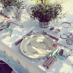 a table set with plates and utensils on it