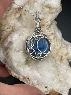 This is a beautiful blue Labradorite moon pendant in Sterling Silver. A complimentary stainless steel chain is included and a gift box, ready for shipping.  All of my pieces are made with high quality wire from Riogrande. These are not costume pieces that will chip away or rust over time. They will last forever if taken care of, which is why I include a free polishing cloth with every order. Quality is very important to me.  If you have any questions, I'm happy to help Celestial Silver Jewelry For Gifts, Celestial Style Silver Jewelry For Gifts, Natural Stones Jewelry Gift, Celestial Sterling Silver Necklace Gift, Celestial Sterling Silver Necklaces As A Gift, Celestial Sterling Silver Necklace For Gift, Unique Stainless Steel Round Pendant Jewelry, Unique Stainless Steel Round Pendant, Celestial Round Pendant Jewelry For Gifts