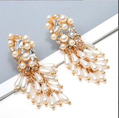 Add a luxurious touch to any outfit with these classic and timeless JLO Earrings. Crafted from pearls imitation and alloy, they are sure to become your go-to accessory. Whether you're dressing up for a night out or adding some sparkle to your office look, these earrings will make a statement. Size: 2.55 in x 0.78 in Main Material: Gold Plated | Stainless Steel Stone: Pearls Material Type: Alloy Warranty: Hypoallergenic | Safe for Sensitive Skin *Slight natural variations may occur between colors White Clip-on Pearl Earrings For Evening, Formal Pearl Clip-on Earrings, Elegant Beaded Drop Earrings For Formal Occasions, Glamorous Pearl Chandelier Earrings For Parties, Elegant Formal Beaded Drop Earrings, Party Pearl Chain Drop Earrings, Pearl Drop Earrings For Party, Pearl White Pearl Earrings For Party, Pearl Chain Metal Earrings For Weddings