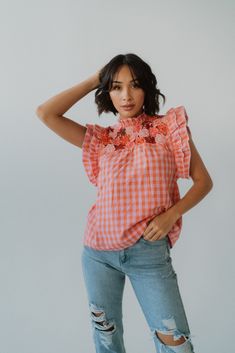 We're upping our wardrobe game with this top! Gingham print Floral detailing Flutter sleeve Keyhole back 100% cotton Model is 5'5" and wearing a size small. XS: 0-2 Small: 2-4 Medium: 6-8 Large: 10-12 Feminine Top With Smocked Back And Flutter Sleeves, Spring Ruffled Collar Top For Brunch, Spring Brunch Tops With Ruffled Collar, Sleeveless Gingham Cotton Top, Summer Cotton Top With Butterfly Sleeves, Summer Cotton Tops With Butterfly Sleeves, Cotton Butterfly Sleeve Top For Summer, Summer Tops With Ruffles And Butterfly Sleeves, Flutter Sleeve Tops With Smocked Back For Spring