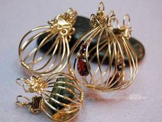 three wire wrapped jewelry pieces sitting next to each other