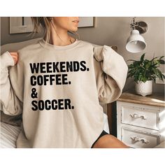 Weekend Coffee Soccer Sweatshirt, Soccer Sweater, Soccer Mom Hoodie, Coffee Lover Sweater, Game Day Sweat, Weekend Hoodie, Soccer Fan Sweat NOTE Black design for White, Sport Grey and Sand. White design for all other colors. Premium quality printed in the USA. Hey there! Welcome to my store, We are glad to see you here. We custom design, print, hand press, and carefully ship everything you see in our shop from our retail shop in New York . All of our items are printed on quality apparel. We have 7/24 customer support please contact us if you have any questions. HOW TO ORDER- 1-) Please, Check and Review all Photos. 2-) Select Your T-shirt Color. 3-) Select Your T-shirt Size. 4-) Choose Your Quantity as much as you want. 5-)Please click the "Proceed to Check Out" button 6-)Finally, your shi Winter Long Sleeve Sweatshirt For Weekend, Letter Print Sweatshirt For Fall Weekend, Letter Print Sweatshirt For Winter Weekends, White Long Sleeve Sweatshirt For Weekend, Long Sleeve Graphic Print Sweatshirt For Weekend, Fall Weekend Sweatshirt With Letter Print, Casual Coffee Sweatshirt For Winter, Soccer Hoodie Ideas, Soccer Mom Cricut Shirt