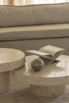 a table that has a book on top of it and a ball on the end