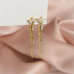 The pair you'll reach for again and again. Add a touch of sparkle to your life with these shimmering gems, designed to complete any look. Handcrafted with a sterling silver base, 14k gold plating and cubic zirconia, these earrings are truly one of a kind. Measuring 40mm in height, they are the perfect accessory to dress up any outfit. Whether you're heading to a party or just running errands, these earrings will add a touch of elegance to your day. Gold Drop Diamond Earrings For Gift, Glamorous Cubic Zirconia Crystal Earrings As Gift, Gold Cubic Zirconia Jewelry For Party, Gold Dazzling Diamond Earrings, Anniversary Gold Plated Drop Diamond Earrings, Gold Diamond Crystal Earrings For Gift, Luxury Dangle Crystal Earrings, Gold Cubic Zirconia Earrings For Anniversary, Dangle Earrings With Diamond Accents And Cubic Zirconia