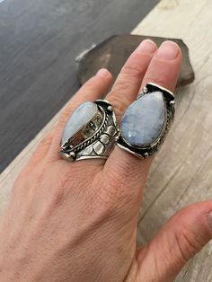 Powerful statement Moonstone rings made with alloy metal. As you can see in the pictures, each ring has a number for you to choose your favorite one, as each stone is unique. They are all size adjustable and unisex. Size 8 would be the smallest recommended and size 11.5- 12 would be the biggest size recommended. From ring 1 to ring 30, the dimension go between the bigger ring and the smaller one which you can see in the pictures with the blue meter. The ring number 31, which is the only one with Bohemian Open Ring Crystal Ring For Healing, Bohemian Open Crystal Ring For Healing, Bohemian Adjustable Crystal Ring With Large Stone, Bohemian Crystal Open Ring With Large Stone, Bohemian Metal Crystal Promise Ring, Bohemian Moon Phase Ring, Bohemian Moon Shaped Gemstone Ring, Handmade Bohemian Crystal Metal Ring, Silver Moon Shaped Bohemian Crystal Ring