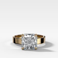 a gold and white ring with a princess cut diamond