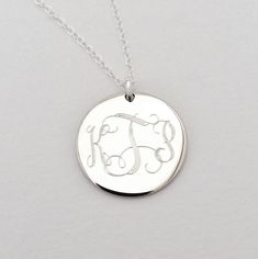 "Monogram Necklace - Wedding Jewelry This sterling silver monogram necklace is a beautiful present for high school or college graduation that is sure to be cherished for a long time to come. I will engrave a monogram or name onto the round pendant. Pendant available in 2 sizes (3/4\" or 1\") **Please provide initials in the order you would like them engraved, for Interlocking Monogram it should be First, Last, Middle.** Pendant - Sterling Silver, 3/4\" diameter or 1\" diameter Necklace- Sterling Silver Medallion Necklace For Anniversary Gift, Classic Engraved Initial Necklace As Gift, Classic Engraved Initial Necklace For Gift, Classic Monogram Initial Necklace For Anniversary, Classic Personalized Name Necklace For Anniversary, Personalized Silver Jewelry With Engraving Option, Classic Initials Name Necklace For Anniversary, Silver Minimalist Monogram Name Necklace, Minimalist Silver Monogram Name Necklace