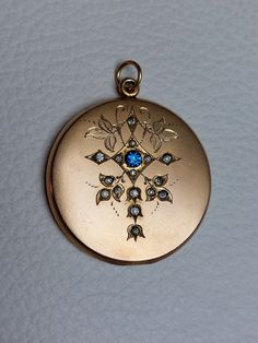 Beautiful Antique Statement Locket with fine engravings, blue, clear rhinestones, and monogram "TS" at the back. Details: The locket was made by the well-known W&H Company from the USA, which stopped operating in 1922. The logo of the company is stamped inside: W&H Co. inside a heart. It is not stamped for gold content but likely made of gold filled which was the typical material used for W&H Co. jewelry. Condition: It is in excellent antique condition, with gentle surface wear and scratches, an Antique Blue Diamond Jewelry, Blue Medallion Jewelry For Anniversary, Vintage Sapphire Jewelry With Diamond Accents, Antique Diamond Jewelry With Screw Back, Victorian Jewelry With Rhinestones For Anniversary, Victorian Rhinestone Jewelry Gift, Victorian Rhinestone Jewelry For Gifts, Victorian Rhinestone Jewelry For Anniversary, Formal Blue Locket Jewelry