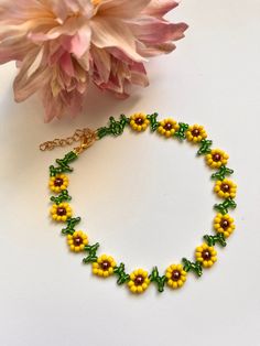 Pretty sunflower design  encompassed in choker necklace Yellow and green glass seed beads Chocolate glass pearl bead centers finished with lobster clasp & extension chain and charm Length option available  Your order will be sent in an organza gift pouch shipping Free delivery on all uk orders International is by Airmail,please see listings for destination/rate I am not a big business but a one woman operation. I pride myself with attention to detail and strive to offer a swift and efficient service. If anything is not to your complete satisfaction I would appreciate to be given the opportunity to put it right BEFORE feedback is left. Any problems: Please send me a message before opening a case as most problems can be quickly & easily resolved . Daisy Chains, Black Leather Choker, Dainty Choker Necklace, Seed Bead Choker, Bead Choker Necklace, Black Velvet Choker, Black Choker Necklace, Sunflower Necklace, Bead Choker