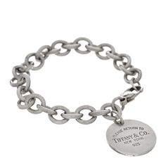 This is an authentic TIFFANY Sterling Silver Return to Tiffany Round Tag Charm Bracelet. The bracelet is crafted of sterling silver and features round links holding a round charm engraved with the 'Return to Tiffany' logo. Tiffany Bracelets, Return To Tiffany, Round Tags, Tiffany Jewelry, Tiffany & Co., Silver Bracelets, Sterling Silver Bracelets, Charm Bracelet, 925 Sterling Silver