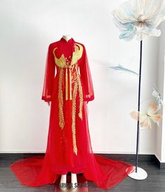 Handmade red bridal Ao Dai with finest Phoenix embroidery by yours truly.  Color :  Red and gold embroidery  Details:  Traditional Vietnamese Ao Dai jacket  Flares Long sleeves  Front closing with button  Cathedral length  Shop other AO DAI: https://etsy.me/3E9ppC7 Turnaround time: Due to the delicate nature of the handcrafted goods we produce this beautiful dress has creation time of approximately 6-10 weeks  Estimated shipping times : ✅Standard shipping: 3-6 weeks for most countries  ✅Expedite Red Floor-length Gown For Traditional Ceremonies, Red Floral Embroidered Dresses With Traditional Drape, Red Dresses With Floral Embroidery And Traditional Drape, Traditional Red Long Sleeve Gown, Traditional Long Sleeve Red Gown, Traditional Red Gown With Long Sleeves, Traditional Red Gown With Floral Embroidery, Ceremonial Red Dress With Traditional Drape, Red Long Sleeve Gown For Ceremonies