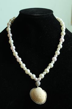 Embrace the summer sun in true style with the Mystic Tides Pendant Necklace! This beauty comes in a pristine white color that instantly lends your look luxury and an ethereal vibe, featuring alternate big and small faux pearls that are complemented with a sphere charm to truly form a look of whimsy and wonder. Rhinestone embellished seashell is sure to brighten up your sunny days. Pair with strapless dresses! Screw Barrel Clasp Closure Material: Faux Pearl Beads, Real Seashell, Elastic String Seashell Pendants, Strapless Dresses, The Mystic, Summer Sun, Pearl Beads, Sunny Days, Faux Pearl, White Color, Sea Shells