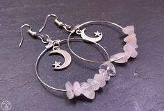 Faerietales proudly presents our celestial and handmade Crescent Moon & Rose Quartz Silver Drop Hoop Earrings! Features a gorgeous hoop design threaded with rose quartz crystals, embellished with a dainty crescent moon and star with a stunning silver finish. Light weight for an extra comfortable wear and simply striking. Product Details:  - Crescent Moon & Rose Quartz Silver Drop Hoop Earrings - Live Your Faerietale  - Includes a unique gift bag and magical spell - Unisex To ensure you keep your earrings in the best condition, please keep it away from excess moisture/water and clean it with a gentle cloth! Dimensions: Length 5cm Width 4cm Shipping: FREE World Wide Shipping All orders placed before 2 pm are shipped the same working day! Magic Included Troll Proof Packaging Returns accepted Moon Earrings Silver, Silver Moon Earrings, Ethereal Jewelry, Fantasy Earrings, Witch Earrings, Celestial Earrings, Hoop Design, Silver Moon, Quartz Crystals