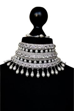 Bridal embroidered necklace in silver tones with white pearls and crystal beads for bride. This necklace can decorate any neck. It can be dressed for a wedding, engagement or for a holiday or New Year's party There are 3  clasps at the back for a secure fit. The length of the chocker is adjustable.  Only high-quality materials were used in the creation of this gorgeous necklace Earrings I put as a gift) length - 31.5 cm (12.2 inch) width - 9 cm (3.4 inch) weight - 135 gram In this necklace you will be absolutely incomparable and unique. You will get a lot of compliments and enthusiastic looks from others  Buying a necklace a pleasant gift awaits you You might also like https://www.etsy.com/shop/AliceCrownStore?ref=seller-platform-mcnav&section_id=35435354 If you have any questions please c Traditional Embellished Wedding Necklaces, Elegant Bridal Accessories With Stone Work In Silver, Silver Choker For Reception, Elegant Silver Bridal Accessories With Stone Work, White Bridal Necklace With Bling For Wedding, White Bling Bridal Necklace For Wedding, White Bridal Sets With Stone Work For Party, Silver Pearl Necklace With Rhinestones For Wedding, Silver Bridal Accessories With Stone Work For Party