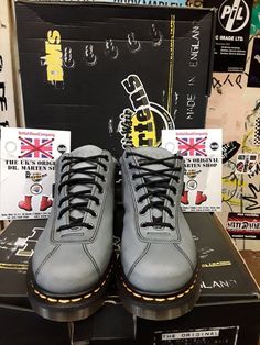 This original Made in England Dr Martens boot is not your usual style they produce, but they are very nice indeed. This is a 7 eyelet ankle boot that has been finished in a neutral blue leather that's very strong and good to wear in all weather's. It has the traditional trade mark yellow stitching and air cushioned sole unit with a BLACK leather strip art the back of the boot. It has potmark holes punched in to the leather on both feet, giving  it that more individual look. Strip Art, Blue Ankle Boots, Neutral Blue, Trade Mark, Hiking Fashion, Danner Mountain Light Boot, Hole Punch, Dr. Martens Boots, Dr. Martens