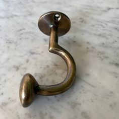 a metal hook on a marble counter top