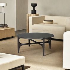 a living room with white couches and black coffee table