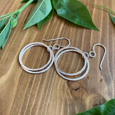 Elegant, Light & Sparkly Double Hoop Earrings -- Beautiful with all of the milestone necklaces. These are perfect for everyday wear.✦ All metal is bright sterling silver.✦ Circles have been given a unique hammered texture, and are organically shaped.✦ Each jump ring has been soldered closed for extra handmade quality.✦ Earrings are 1 5/8 inches long, including the french hook ear wires✦ Largest circles are 7/8" wide. Double Hoop Earrings, Jump Rings, Ear Wires, Circles, Everyday Wear, Hoop Earrings, Necklaces, Texture, Sterling Silver