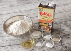 flour, eggs and other ingredients on a wooden table next to a carton of falcon