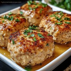 three meat patties on a plate with parsley