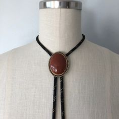 A lovely vintage bolo in perfect condition! Great gift for someone this holiday season! Introduction to Goldstone: Here's some good advice 🪶 Keep calm and carry the Goldstone crystal to ensure a golden future. Because let's be realistic--the mysterious abyss of the unknown--also known as the future--can be a daunting aspect. Known as the 'ambition' stone, the Goldstone crystal meaning is linked with boosting your drive and confidence, the essential mindset for paving the way for all your dreams 70s Jewelry Necklaces, Western Jewelry With Adjustable Chain, Western Lariat Jewelry As Gift, Western Style Jewelry With Adjustable Chain, Western Style Lariat Jewelry As Gift, Western Style Lariat Jewelry For Gifts, Western Style Lariat Necklace For Gifts, Handmade Western Lariat Jewelry, Handmade Western Lariat Necklace