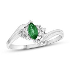 A marvelous choice for day or night, this charming gemstone and diamond ring makes creating a chic look easy. Crafted in 14K white gold, this graceful style features a rich 6.0 x 3.0mm marquise-cut verdant-green emerald. Trios of sparkling diamonds flank the center stone while the sculpted double ribbons of the shank bypass around the center. Radiant with 1/20 ct. t.w. of diamonds and a brilliant buffed luster, this ring gleams with exquisite design. Formal Birthstone Ring In Diamond White With Accent Stones, Formal Diamond White Birthstone Ring With Accent Stones, Classic White Gold Diamond Ring For May Birthstone, Formal Diamond Ring With Prong Setting For May Birthstone, Formal May Birthstone Diamond Ring With Prong Setting, White Gold Diamond Cluster Ring - May Birthstone, Diamond May Birthstone Ring With Center Stone, White Gold Diamond Cluster Ring For May Birthstone, Diamond Birthstone Ring With Center Stone For May