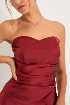 Make your entrance looking like an absolute princess in the Lulus Sweetheart Soiree Wine Red Satin Strapless Bubble-Hem Mini Dress! This fabulous little dress has a sleek woven satin composition that shapes an elegant sweetheart neckline (with hidden no-slip strips) and a fitted, strapless bodice with hidden supportive boning. Pleating along the sides creates a draping effect across the A-line silhouette that falls to a pointed bubble hem. Hidden back zipper/clasp. Fit: This garment fits true to Flirty Bridesmaid Dress With Corset Back, Flirty Satin Dress With Sweetheart Neckline, Elegant Ruched Dresses With Heart-shaped Neckline, Heart-shaped Neckline Prom Dress, Flirty Dresses With Pleated Bodice And Sweetheart Neckline, Flirty Bridesmaid Dress With Sweetheart Neckline, Elegant Red Dress With Corset Back, Red Mini Dress With Ruched Bodice For Date Night, Red Sweetheart Neckline Dress With Corset Back