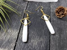 "These long white and gold drop earrings feature 39mm flat white acrylic teardrop beads, overlaid at the top with 12mm gold-plated brass open square links. These lightweight earrings transition effortlessly from office wear to street wear, and are lightweight enough to wear all day. These white drop earrings measure 2.5 inches from the bottom of the teardrop to the top of the ear wires, which are made of hypoallergenic gold-plated surgical steel. Domestic shipping is always free here at MayaMade White Long Drop Earrings For Gift, Modern White Drop Earrings, Minimalist White Teardrop Earrings For Gift, White Long Drop Teardrop Earrings With Ear Wire, White Modern Drop Earrings, White Dangle Teardrop Earrings For Gift, White Minimalist Hypoallergenic Teardrop Earrings, White Teardrop Dangle Earrings Gift, White Long Drop Teardrop Earrings