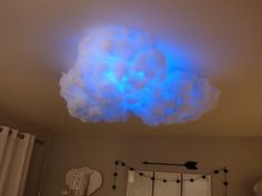 there is a cloud in the ceiling with blue lights