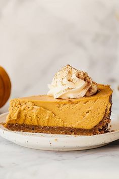 a slice of pumpkin pie on a white plate