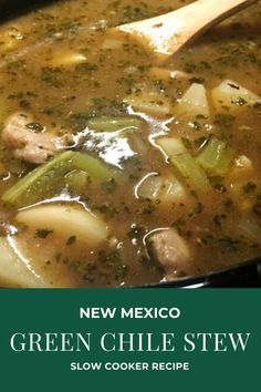 green chile stew in a black pot with a wooden spoon