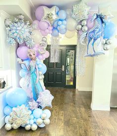 the balloon arch is decorated with blue, white and silver balloons for a frozen princess themed birthday party