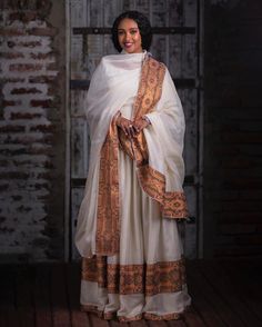 The Habesha Kemis is a true masterpiece of Ethiopian fashion, embodying the rich cultural heritage and artistic traditions of the region. This traditional attire showcases the incredible skill and dedication of Ethiopian artisans who meticulously handweave every intricate detail. One of the defining features of the Habesha Kemis is the use of Menen fabric, which adds a touch of elegance and charm to this already stunning attire. Menen fabric is made from high-quality materials, carefully selecte Habesha Kemis Modern, Habesha Dress Modern, Modern Habesha Dress, Ethiopian New Year, Ethiopian Fashion, Eritrean Dress, Ethiopian Clothing, Habesha Dress, Ethiopian Traditional Dress